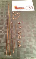 All nine gold jewelry pieces laid out