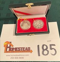 Open presentation box displaying two encapsulated 1989 Silver Panda coins