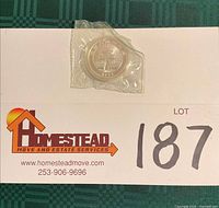 Coin sealed in plastic capsule on lot card