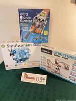 Front view of three boxed STEM kits: Ultra Bionic Blaster, Smithsonian Motor-Works, Discovering STEM Structures Buildings & Bridges