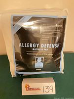 Front view of packaged Allergy Defense queen mattress pad