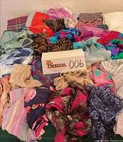 Pile of assorted scarves showing variety of colors and patterns