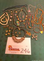 Full lot overview showing all jewelry pieces spread on table