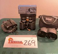 Overall lot view showing all optical devices and cases