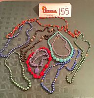 All ten stone bead necklaces laid out to show colours and lengths.
