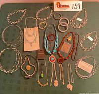 Overview of all jewellery pieces laid out on green cloth