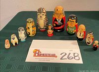 Full group of 11 visible nesting dolls around lot card