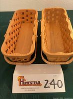 Both Frank Smith woven oval baskets side by side with lot card
