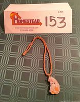 Full view of necklace with pendant and lot tag