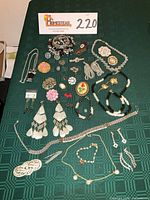 All jewelry laid out on green cloth showing full assortment