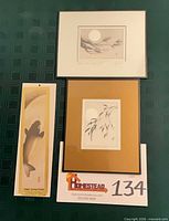 Overall lot showing two framed artworks and packaged copper koi picture