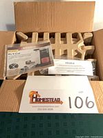 Open shipping box with manuals and cardboard inserts visible