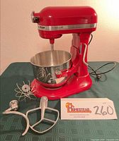 Mixer with bowl and attachments displayed