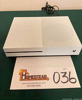 Front view of white Xbox One S with power cable