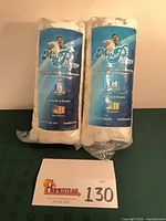 Two rolled MyPillow pillows in original packaging with lot card visible