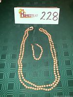 Necklace and bracelet laid out on surface