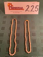 Both necklaces displayed side by side with lot card