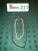 Both necklaces laid flat showing full strands