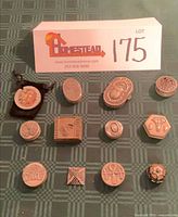 Group shot of all 12 pill boxes arranged under lot card