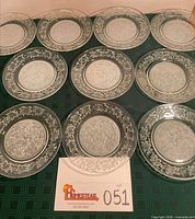 All ten clear crystal dinner plates displayed face up