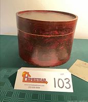 Front view of red painted bent wood hat box