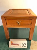 Front view of red beech short stool showing drawer and legs