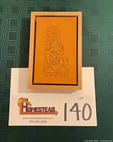 Framed tooled leather panel in cherry wood frame overview