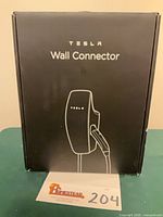Front of sealed Tesla Wall Connector box