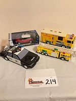 Group shot showing boxed Mini Cooper, Metro Police car, Metro Fire Rescue truck, BP ladder truck