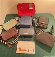 Group shot of 7 bags arranged on surface with lot card