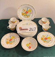 Full set front view showing plates, bowls, cups, saucers
