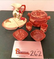 All eight pottery pieces arranged together