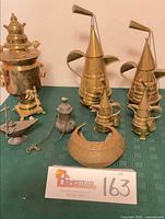 Group shot of samovar, five brass coffee pots, bowl, oil lamp, pewter pot and chain
