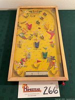 Full view of Poosh-M-Up Big 5 bagatelle in wood frame