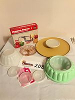 Group shot of all items including boxed apple parer, chip & dip tray, molds, glass dish