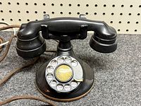 Front view showing handset, cradle, rotary dial and cloth cord