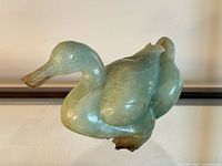 Left profile of jade duck sculpture