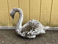 Right side view of concrete swan planter