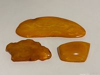 Front view of all three amber brooches