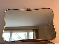 Front view of gold framed mirror