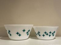 Both Pyrex Atomic bowls side by side showing sizes and motif
