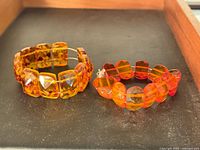 Both amber bracelets side by side in tray