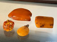 Group shot of four amber jewellery pieces