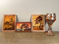 Group shot: three framed amber artworks and amber-decorated chalice