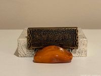 Front view showing engraved forest plate and amber drop