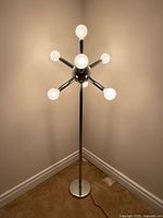 Full floor lamp illuminated, showing entire height and base