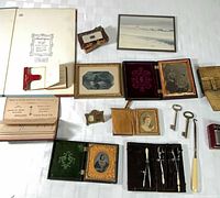 overview of lot showing books, cased photos, drafting set, keys, cigarette items, tortoiseshell box