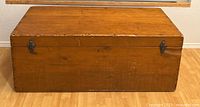 Front view of antique pine chest with lid closed