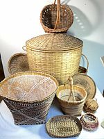 Group shot of all baskets including lidded hamper and nine assorted baskets