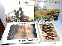 Four large art books front covers visible